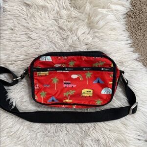 LeSportsac Daniella crossbody bag in‎ a red print featuring a camping motif
